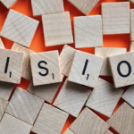 numberes scrabble squares with letters spell the word vision